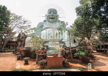 Photo en petit angle d'une statue de Bouddha en riant à la pagode de Vinh Trang, au Vietnam Banque D'Images