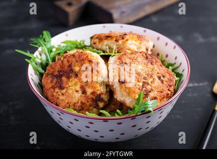 Dîner sain. Côtelettes de poulet dans un bol sur fond sombre. Banque D'Images