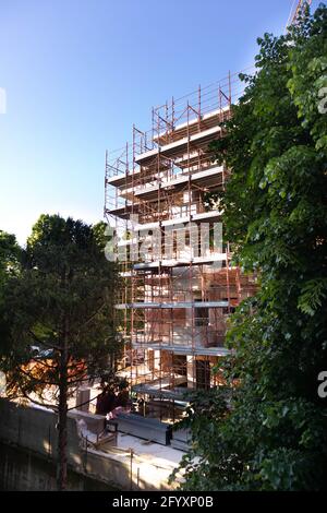 bâtiment en construction avec échafaudage, grue jaune et ciel bleu Banque D'Images