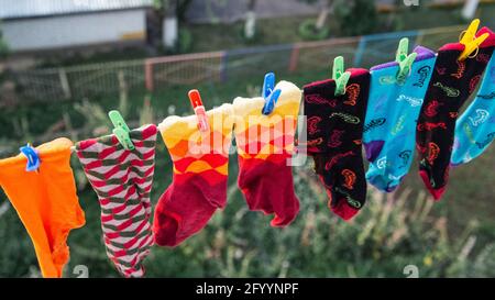 Les chaussettes multicolores sont séchées sur une corde Banque D'Images