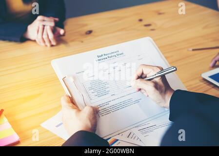 Job applicants having an interview with Human resource manager jobs interview with confident candidate in an office. Stock Photo