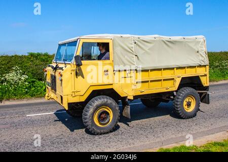 1977 70s toile de camion jaune de l'armée britannique Land Rover 101 des années soixante-dix, quatre roues motrices extra-robustes en route vers le spectacle automobile classique de Capesthorne Hall de mai, Cheshire, Royaume-Uni Banque D'Images