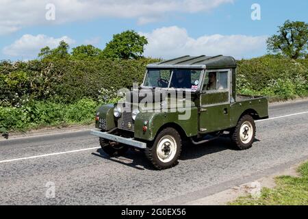 1958 50s SWB 90 Land Rover Green essence pick-up à cabine simple ; circulation routière, véhicules en mouvement, voitures, véhicule roulant sur les routes du Royaume-Uni, moteurs, conduite sur le réseau routier du Royaume-Uni. Conduite sur les routes de campagne en route vers Capesthorne Hall, salon automobile classique à Cheshire. Banque D'Images