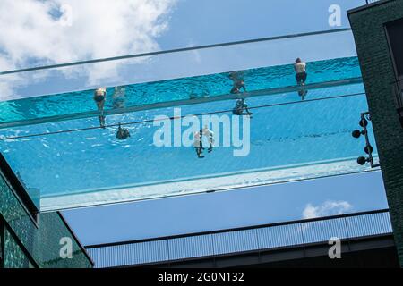 LONDRES 2 juin 2021 . Les nageurs se rafraîchissez au skypool transparent des jardins de l'Embassy à Londres lors d'une autre journée chaude dans la capitale lors d'une mini-vague de chaleur avec des températures supérieures à 25 °C. Le skypool à Embassy Gardens est la première piscine flottante au monde suspendue à 35 mètres (115 pieds) au-dessus du sol développée par EcoWorld Ballymore et forme un pont entre deux immeubles d'appartements qui ont ouvert le 19 mai 2021. Credit amer ghazzal/Alamy Live News Banque D'Images