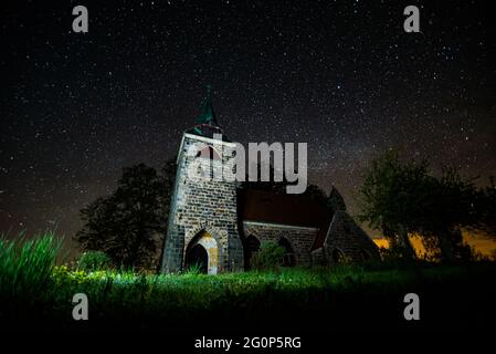 Église du cœur Divin du Seigneur avec ciel nocturne plein d'étoiles en arrière-plan dans le petit village Borovnicka, république tchèque Banque D'Images