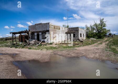 Delhi, Colorado - 18 mai 2021 : la station-service et le magasin général abandonnés One Stop dans la ville fantôme des Prairies de Delhi, Colorado Banque D'Images