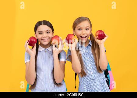 Des enfants heureux de retour à l'école tenant des pommes pour une alimentation saine, la nutrition de l'enfance Banque D'Images