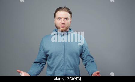 Photo d'un jeune homme surpris en sweat-shirt bleu Banque D'Images