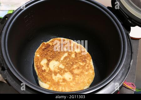 Faire cuire du pain plat dans la machine de cuisine multicuiseur. Banque D'Images