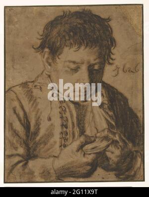 Garçon cueillant des puces, demi-longueur. Banque D'Images