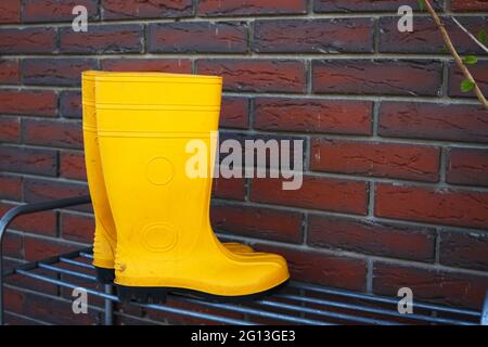 bottes en caoutchouc jaune près de l'entrée de la maison Banque D'Images