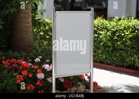 Panneaux publicitaires verticaux blancs au milieu du jardin Banque D'Images