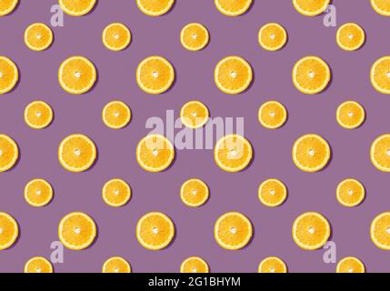 Motif de fruits à partir de tranches d'orange sur fond violet. Pose à plat Banque D'Images