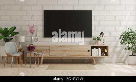 Mockup une télévision dans un salon moderne avec fauteuil et plante sur mur de brique.rendu 3d Banque D'Images