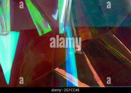 Arrière-plan holographique abstrait multicolore. Rouge foncé, bleu et vert, style futuriste rétro. Banque D'Images