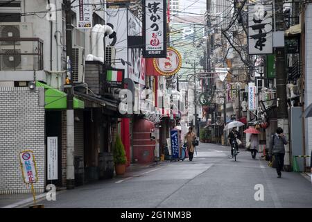 OSAKA, JAPON - 06 décembre 2019 : Osaka, Japon - 02 décembre 2019 : personnes avec parasols dans la rue humide en journée de pluie à Osaka, Japon. Banque D'Images