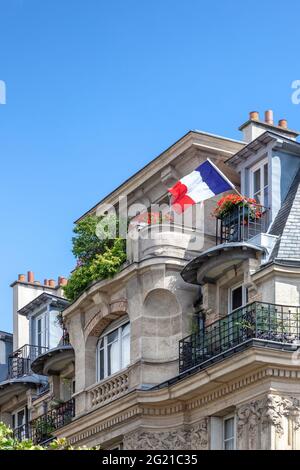 Drapeau français du jour de la Bastille, sur le balcon de l'appartement dans le 12ème arrondissement, Paris, France Banque D'Images