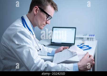 Sujet de la vérification rapide de la maladie cardiaque. Maladie cardiaque infarctus du myocarde. Médecin analysant l'électrocardiogramme au bureau de l'hôpital Banque D'Images