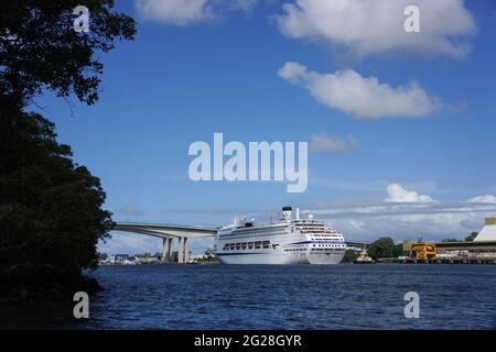 Un grand paquebot de croisière blanc sur le point de passer sous le pont Gateway Bridge sur le fleuve Brisbane dans le Queensland Australie au début d'un voyage de vacances heureux. Banque D'Images
