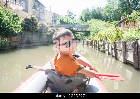 Un kayak familial dans le Parc naturel régional du Marais Poitevin sur des kayaks gonflables lors de vacances d'été en France Banque D'Images