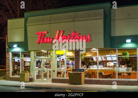 Le restaurant de Tim Horton pendant une nuit d'hiver avec de la neige. Tim Hortons Inc. Est un restaurant multinational canadien à l'ambiance rapide et décontractée, connu pour son café et son café Banque D'Images