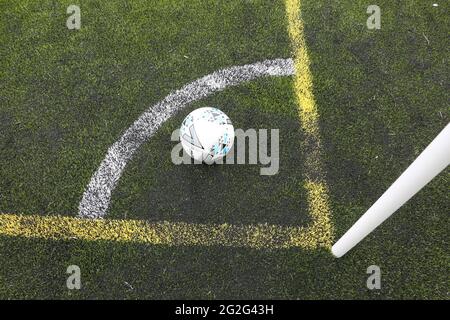 Painted markings line on all weather surface. Corner post and corner marking with football Banque D'Images