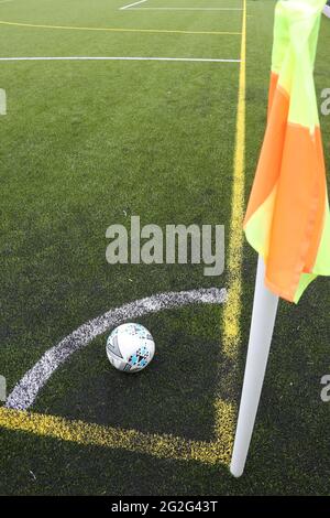 Painted markings line on all weather surface. Corner post and corner marking with football Banque D'Images