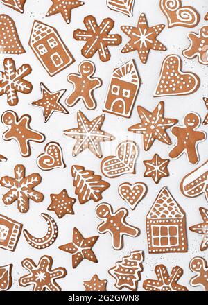 Beau pain d'épice maison de Noël biscuits sous forme d'homme, d'étoile, de coeur, d'arbre, de flocons de neige, maison sur fond clair. Vue de dessus. Banque D'Images