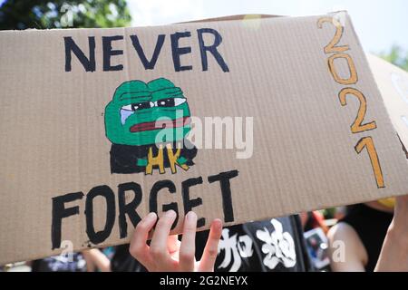 Un militant pro-démocratie tient un écriteau lors d'un rassemblement pour marquer le deuxième anniversaire des manifestations pro-démocratie massives qui ont déraciné Hong Kong en 2019. Banque D'Images