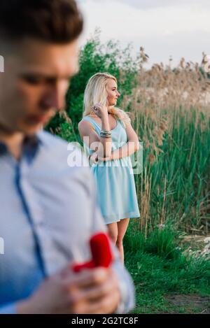 Homme demandant à sa petite amie si elle veut l'épouser. Coucher de soleil Banque D'Images