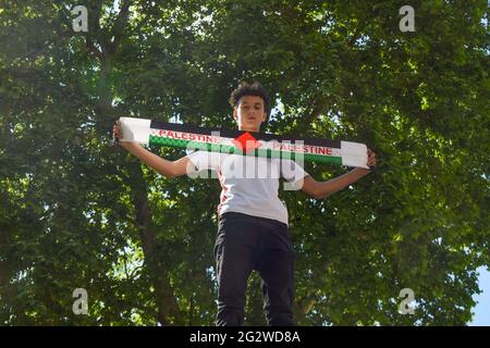 Londres, Royaume-Uni. 12 juin 2021. Un manifestant tient un foulard palestinien lors de la manifestation du juge pour la Palestine. Des milliers de personnes ont défilé à travers Londres pour exiger la justice pour la Palestine et ont appelé le G7 à mettre fin à la coopération militaire avec Israël et à imposer des sanctions. (Photo de Vuk Valcic/SOPA Images/Sipa USA) crédit: SIPA USA/Alay Live News Banque D'Images