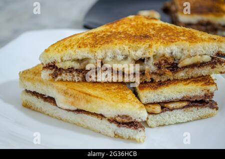 Morceaux de sandwich Banana au chocolat, délicieux et prêts à manger dans une assiette. Prise de vue macro Banque D'Images