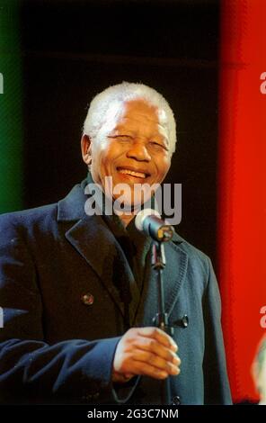 Nelson Mandela, avec un microphone, sourit à la foule lors du concert de la Journée de la liberté de l'Afrique du Sud sur la place, Trafalgar Square, Londres, Royaume-Uni. Banque D'Images