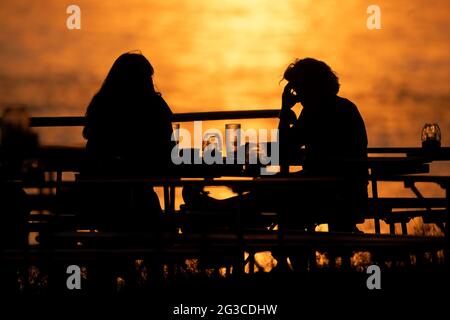 Wiesbaden, Allemagne. 15 juin 2021. Personnes assises dans un café en plein air au coucher du soleil. Credit: Sebastian Gollnow/dpa/Alay Live News Banque D'Images