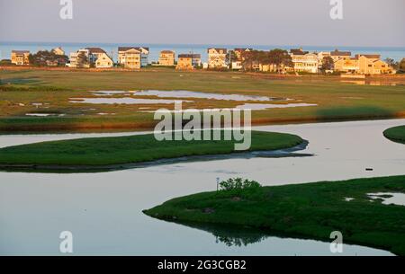 La rivière Ogunquit au coucher du soleil Ogunquit, dans le Maine, en fin d'après-midi de printemps, aux États-Unis. Maisons d'été de Wells, Maine en arrière-plan. Banque D'Images