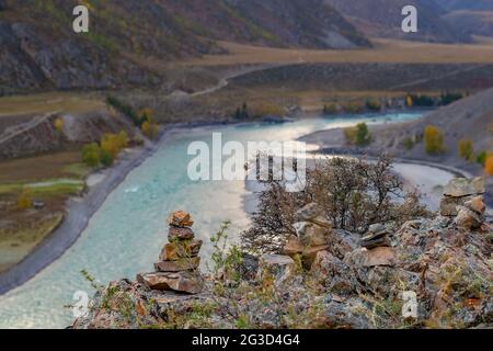 pierres empilées dans une pyramide sur le fond d'un paysage avec une vallée de rivière Banque D'Images