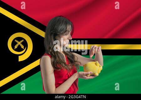 L'économie au Vanuatu. Accumuler et économiser de l'argent au Vanuatu. Femme mettant la pièce d'argent dans la banque de piggy pour économiser de l'argent et de planifier le financement Banque D'Images