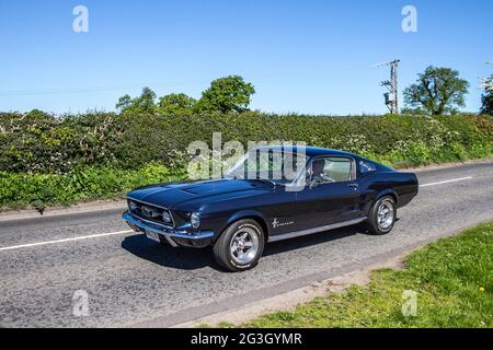 Années 1967 60 années soixante noir américain Ford Mustang Auto 4736 cc roadster essence, en route pour Capesthorne Hall classique mai salon de voiture, Cheshire, Royaume-Uni Banque D'Images