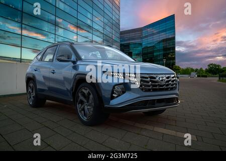 Hyundai Tucson dans le parking en face d'un immeuble de bureaux moderne Banque D'Images