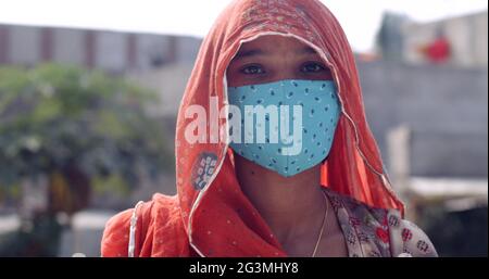 Coup de tête d'une femme d'Asie du Sud portant un foulard et un masque facial de protection Banque D'Images
