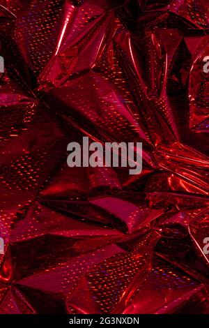 L'arrière-plan de film d'emballage holographique froissé avec un motif abstrait. Banque D'Images