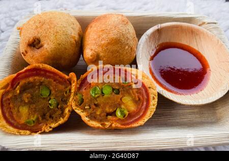 Délicieux en-cas de thé indien Tomato bhajiya ou beignets frits à la tomate . Pakoda de tomate servie dans une assiette avec trempette au ketchup Banque D'Images