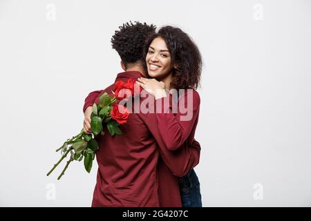 Concept - Jeune couple couple huging les uns les autres et la tenue rouge romantique rose. Banque D'Images