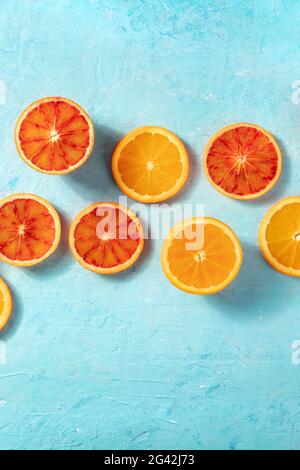Oranges de différents types, tiré depuis le haut sur un fond bleu Banque D'Images