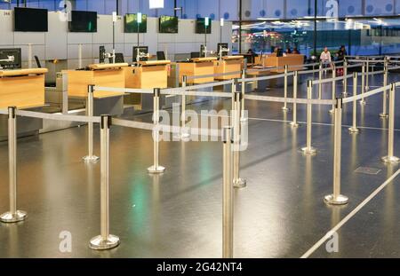 Schwechat, Autriche - 22 avril 2019 : zone d'attente vide divisée par des limites de bande aux comptoirs d'enregistrement de l'aéroport de Vienne, floue à l'arrière-plan des personnes Banque D'Images