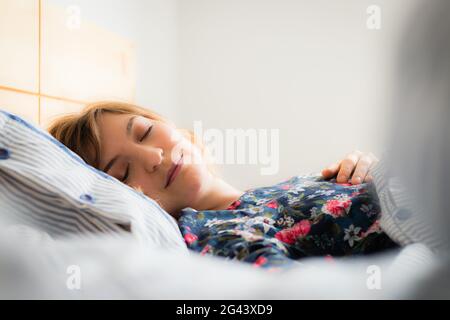 Sommeil reposant : une jeune femme dormait dans son lit, en gros plan Banque D'Images