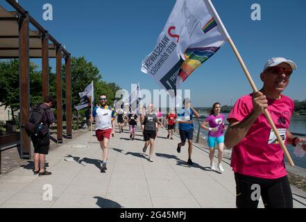 Varsovie, Varsovie, Pologne. 19 juin 2021. Les participants du Jog Egalité détiennent des drapeaux lors de leur course le 19 juin 2021 à Varsovie, en Pologne. Une douzaine de personnes ont participé au 2e Jog Egalité, organisé par le groupe activiste Homokomando, qui consiste en un parcours de 5 km et qui a lieu avant la parade de la fierté de Varsovie. Crédit: Aleksander Kalka/ZUMA Wire/Alay Live News Banque D'Images