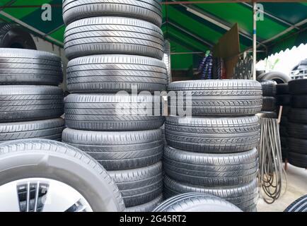 Plusieurs pneus de voiture sont alignés dans un atelier de pneus. Banque D'Images