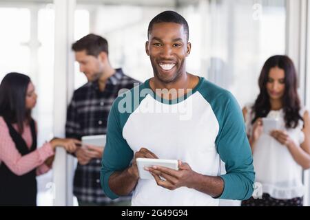 Portrait of happy businessman using digital tablet Banque D'Images