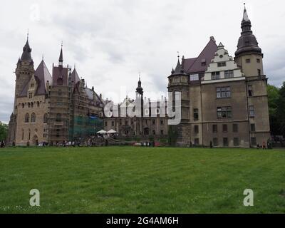 Palais dans la ville européenne de Moszna à Opole Voivodeship en Pologne avec ciel nuageux en 2021 froid jour de printemps sur Mai. Banque D'Images